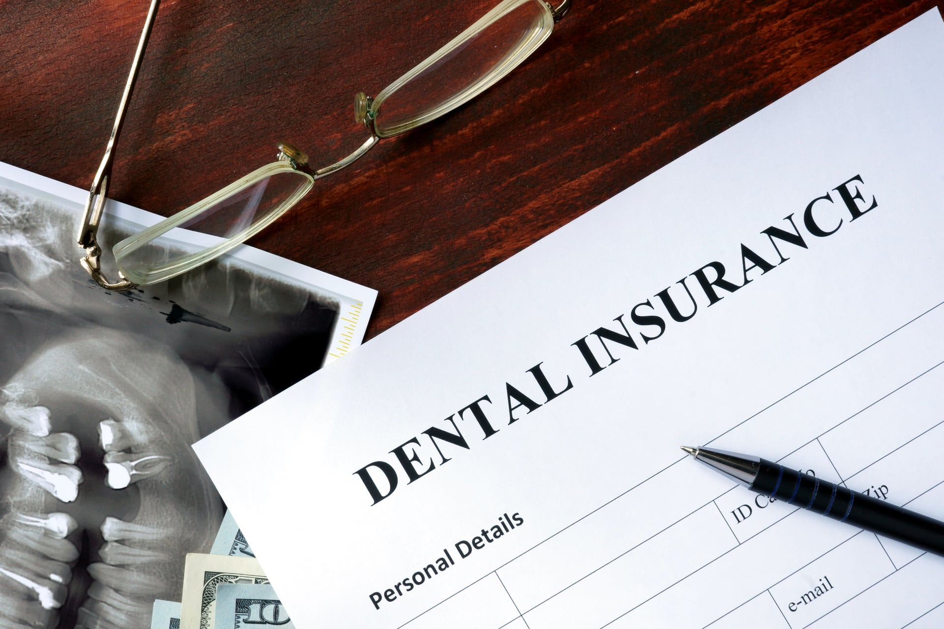 Dental insurance form on the wooden table.